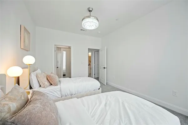 a bedroom with a bed and painting on the wall