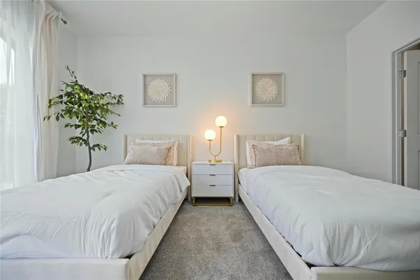 a bedroom with bed and a potted plant