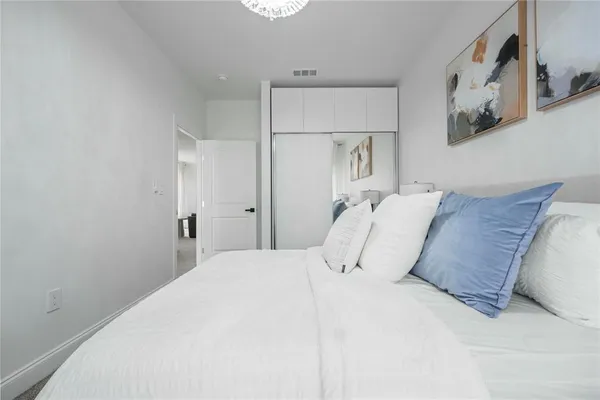 a large white bed in a white room