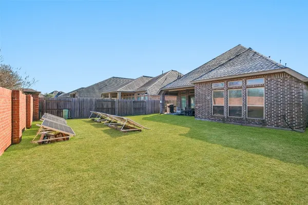 a view of a house with a swimming pool and a yard