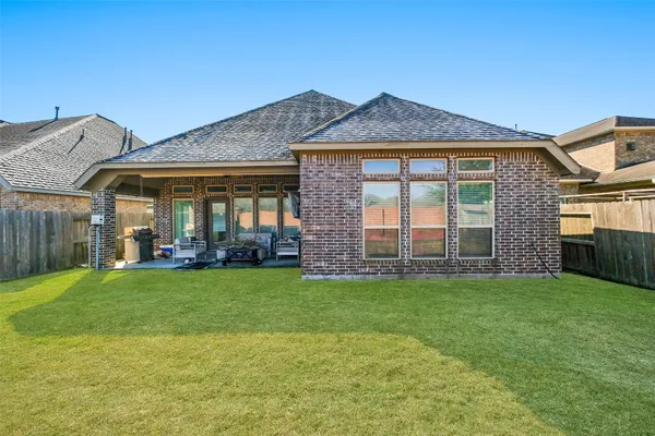 a view of a brick house with a yard