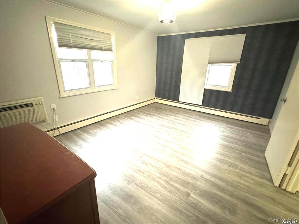 107 Baker Hill Road Great Neck, NY 11023 - Photo 16 of 29 a view of an empty room and wooden floor