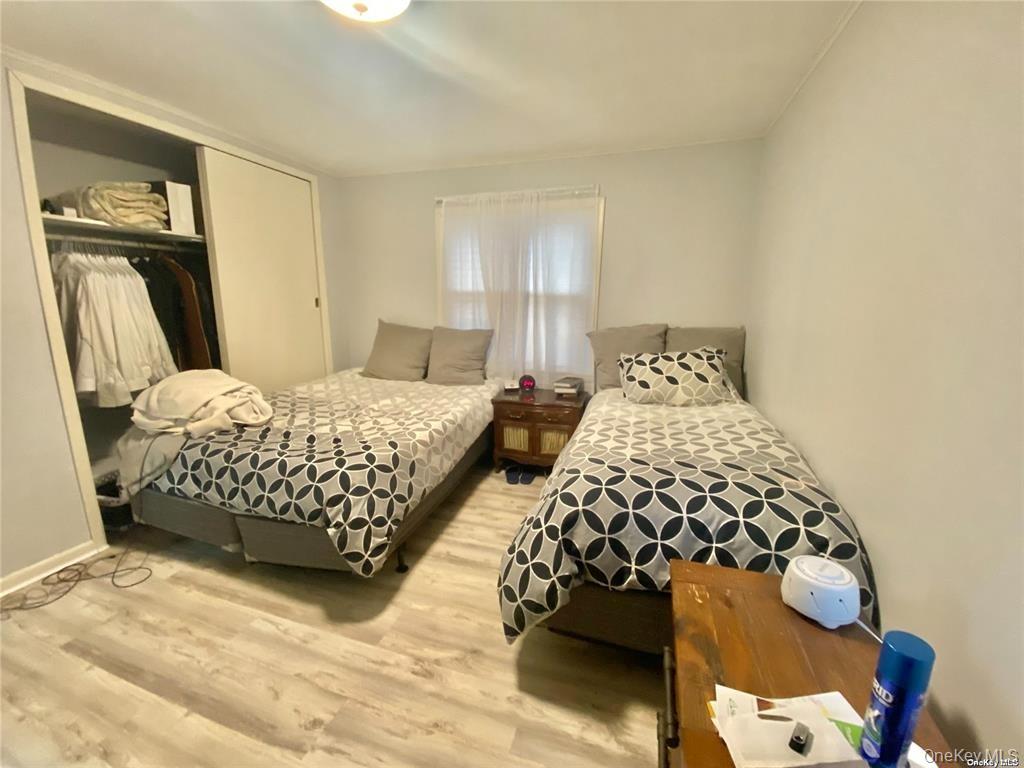 107 Baker Hill Road Great Neck, NY 11023 - Photo 18 of 29 a bedroom with two beds and painting on the wall