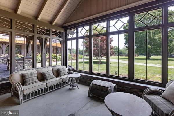 a living room with stainless steel appliances granite countertop a stove a sink dishwasher and cabinets with wooden floor