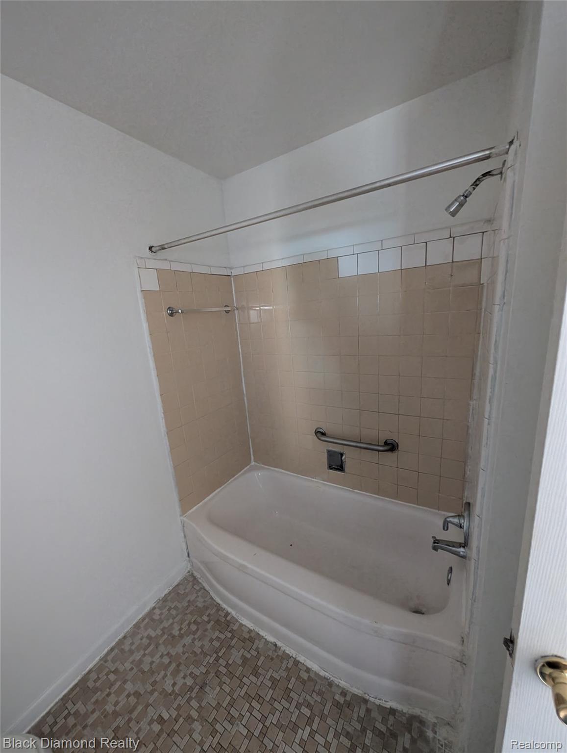 16217 Greenfield Road Detroit, MI 48235 - Photo 13 of 16 Bathtub with a tiled surround, integrated showerhead, and a mosaic tile floor