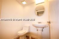 13936 Southwest 46th Terrace, Unit B Miami, FL 33175 - Photo 5 of 11 a bathroom with a toilet sink and mirror