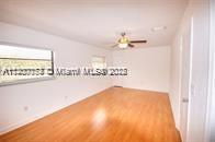 13936 Southwest 46th Terrace, Unit B Miami, FL 33175 - Photo 7 of 11 a view of a room with cabinet and floor to ceiling window