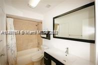 13936 Southwest 46th Terrace, Unit B Miami, FL 33175 - Photo 8 of 11 a bathroom with a bathtub and a sink