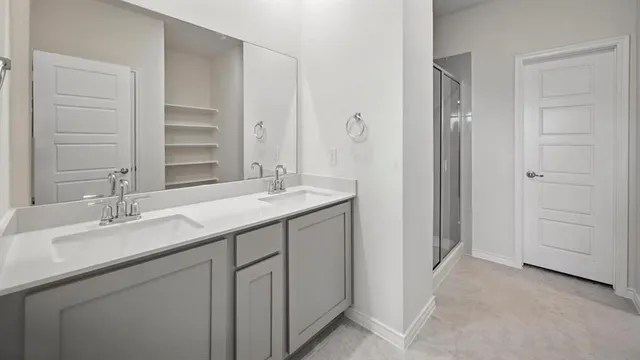 a bathroom with a double vanity sink and a mirror