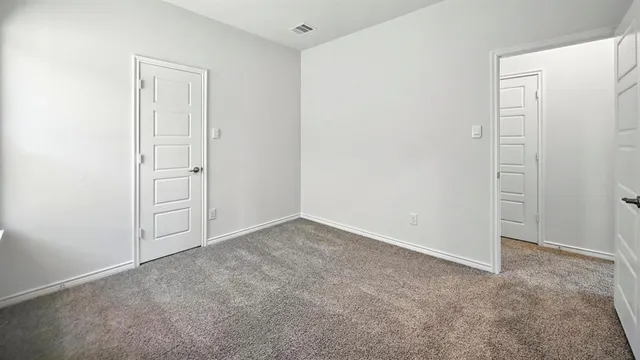an empty room with closet area