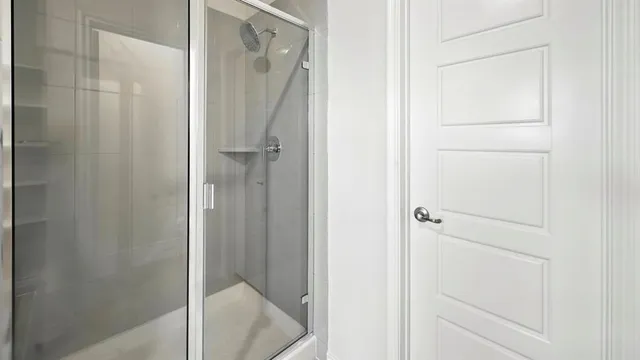 a bathroom with a glass shower door