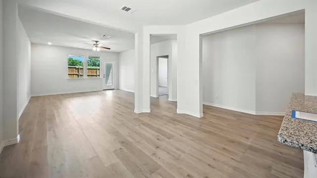 wooden floor in an empty room with a window
