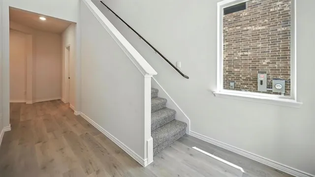 a large kitchen with stainless steel appliances granite countertop a stove a sink and a microwave