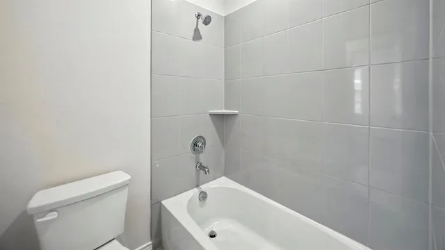 a bathroom with a bathtub and toilet