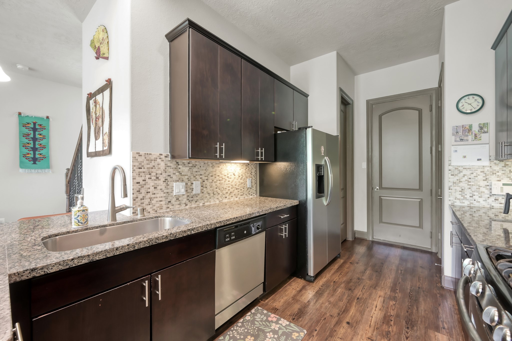 18 Aventura Place Spring, TX 77389 - Photo 17 of 43 a kitchen with granite countertop a sink and a refrigerator