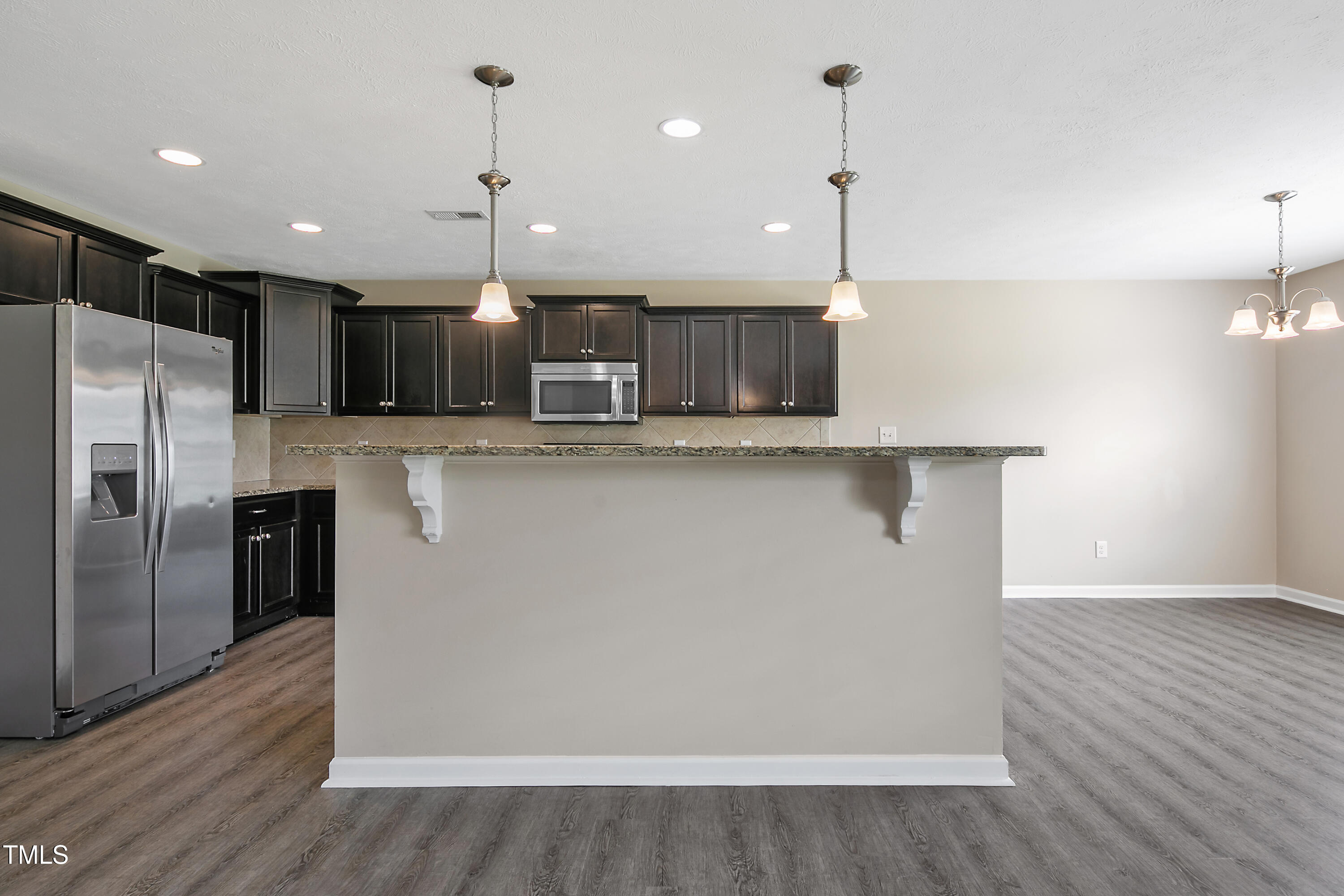 949 Raspberry Road Stedman, NC 28391 - Photo 11 of 31 a kitchen with kitchen island a sink stainless steel appliances and wooden floor