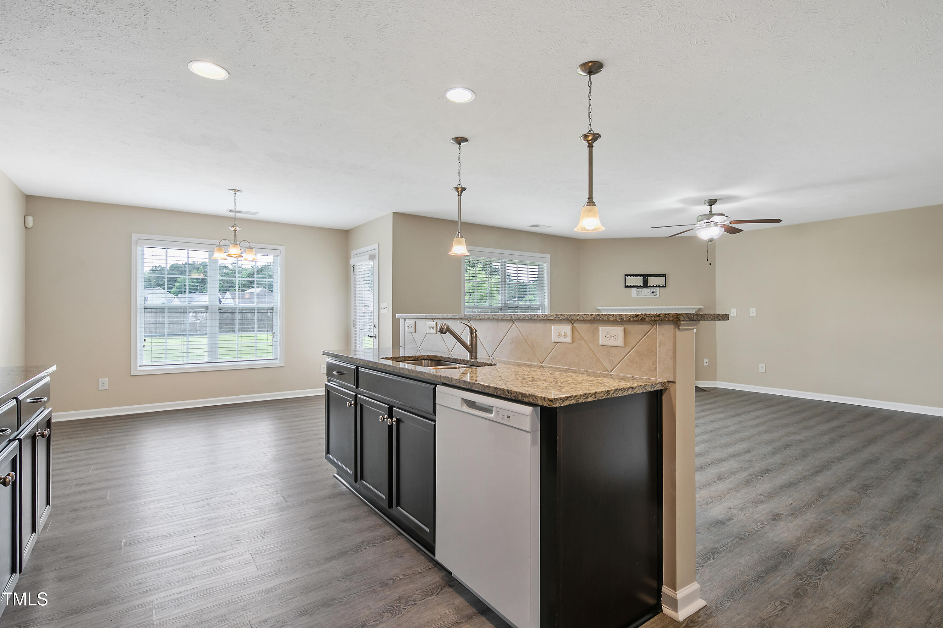 949 Raspberry Road Stedman, NC 28391 - Photo 13 of 31 an open kitchen with a sink and dish washer