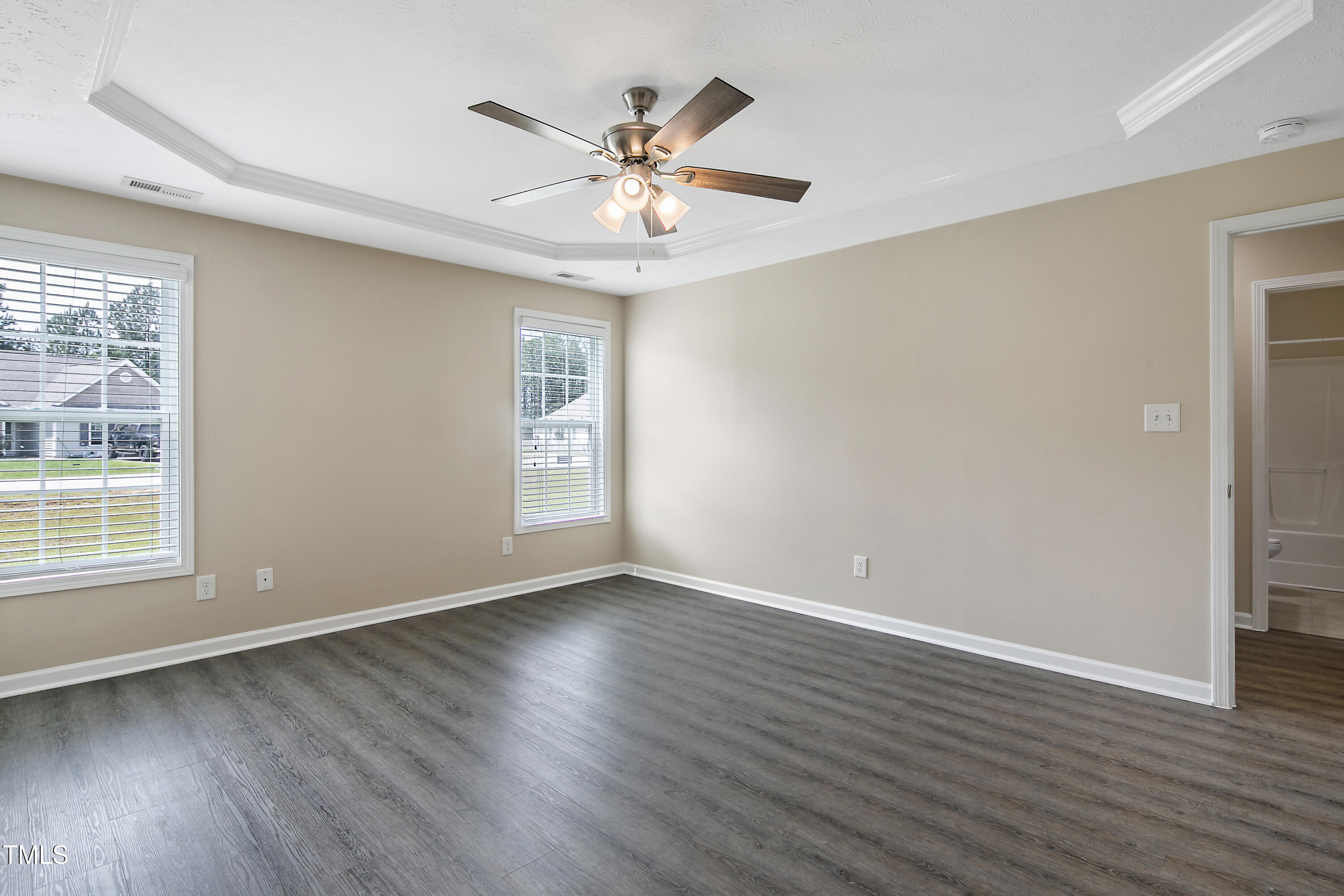 949 Raspberry Road Stedman, NC 28391 - Photo 15 of 31 an empty room with wooden floor chandelier fan and windows