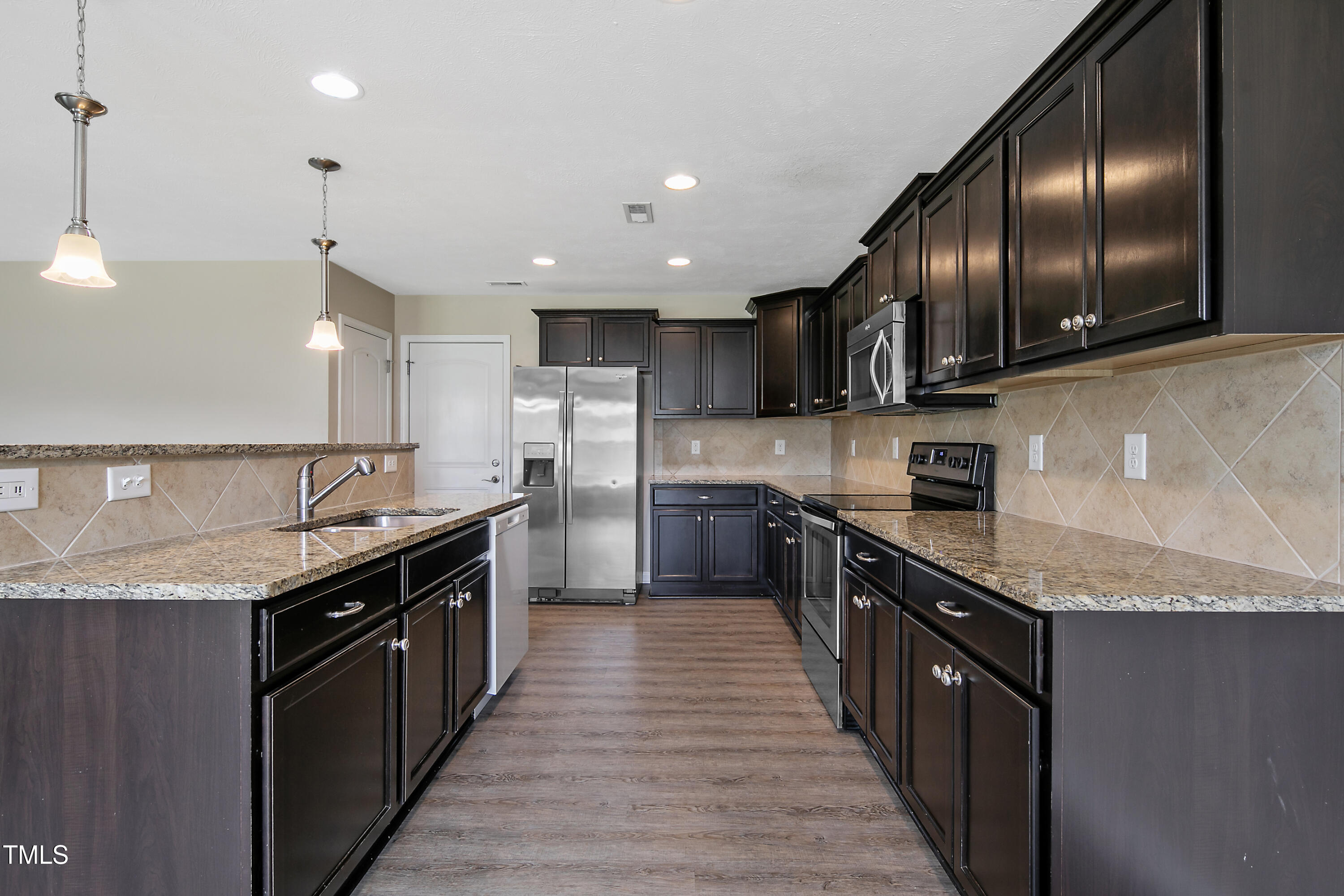 949 Raspberry Road Stedman, NC 28391 - Photo 2 of 31 a large kitchen with stainless steel appliances granite countertop a counter top a stove and a sink