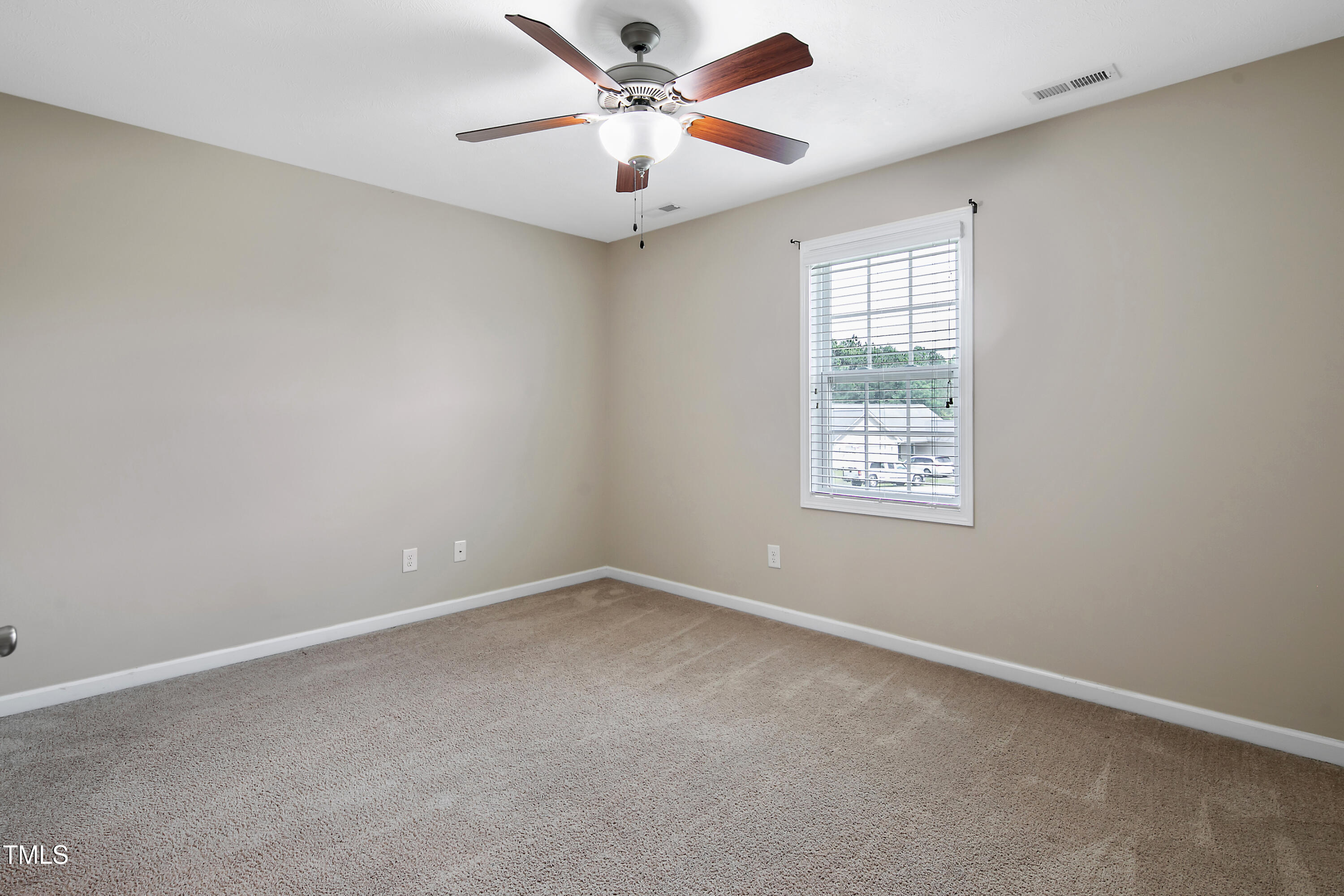 949 Raspberry Road Stedman, NC 28391 - Photo 27 of 31 an empty room with a window and a fan