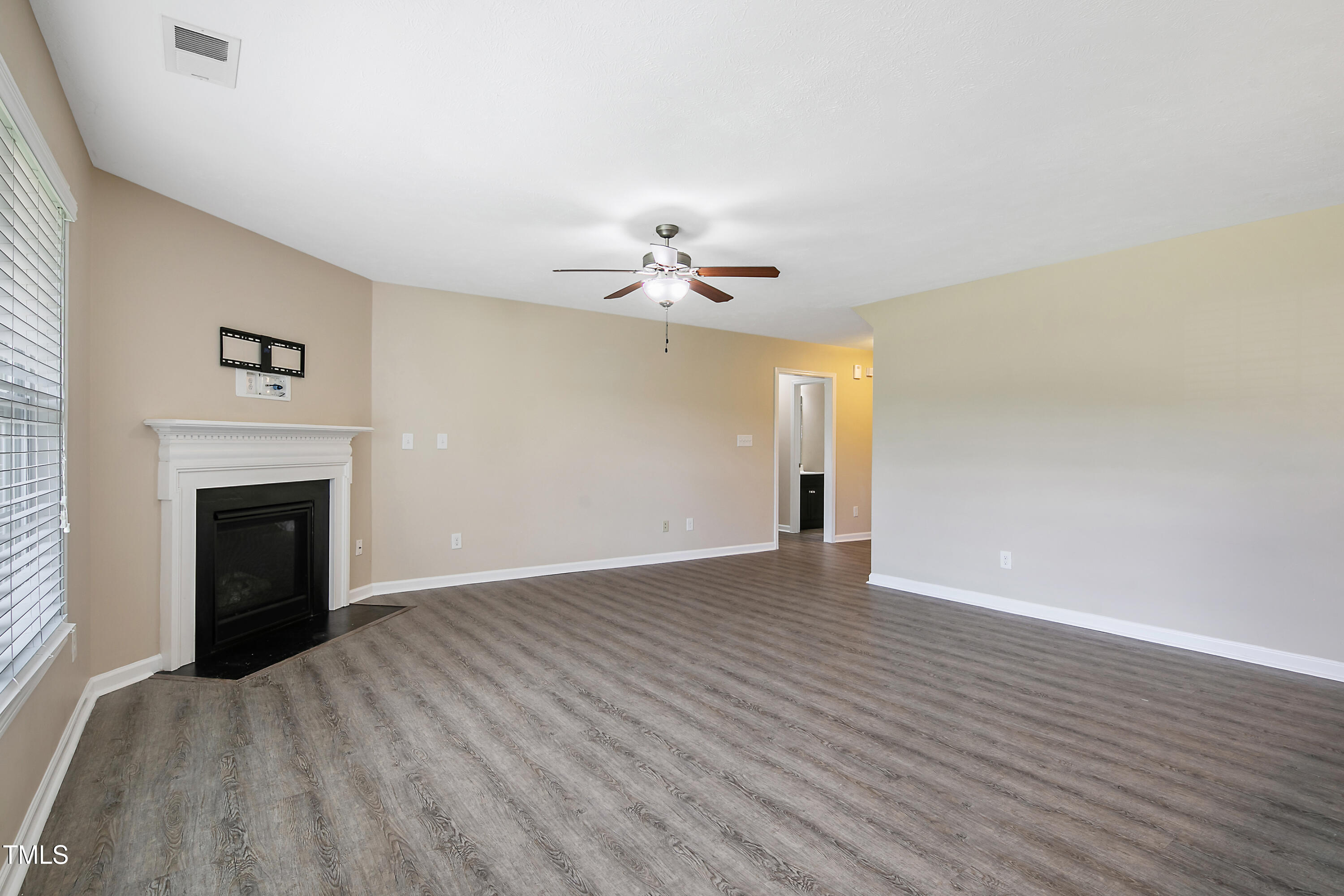 949 Raspberry Road Stedman, NC 28391 - Photo 3 of 31 a view of an empty room with a fireplace and a window