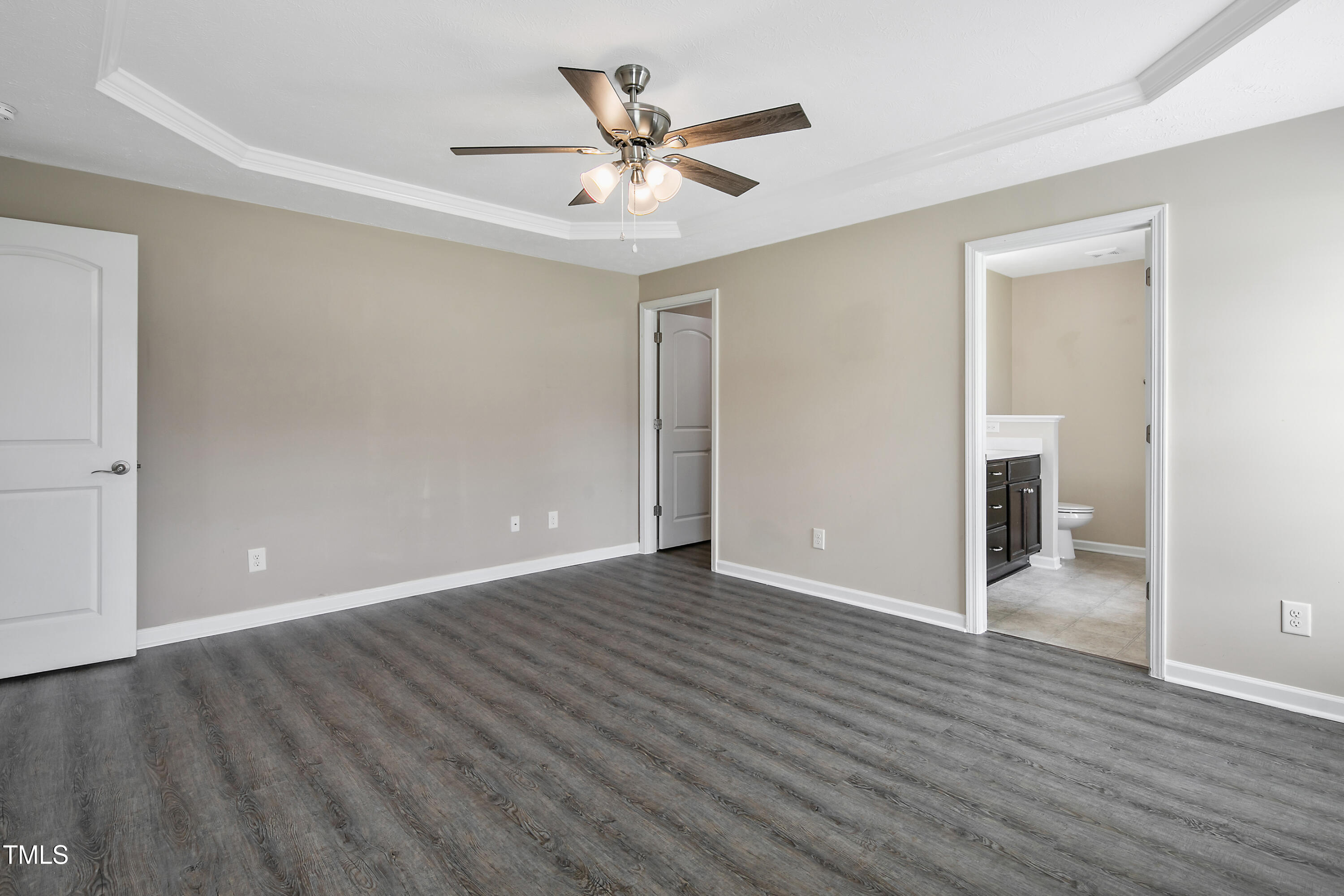 949 Raspberry Road Stedman, NC 28391 - Photo 5 of 31 an empty room with wooden floor and ceiling fan