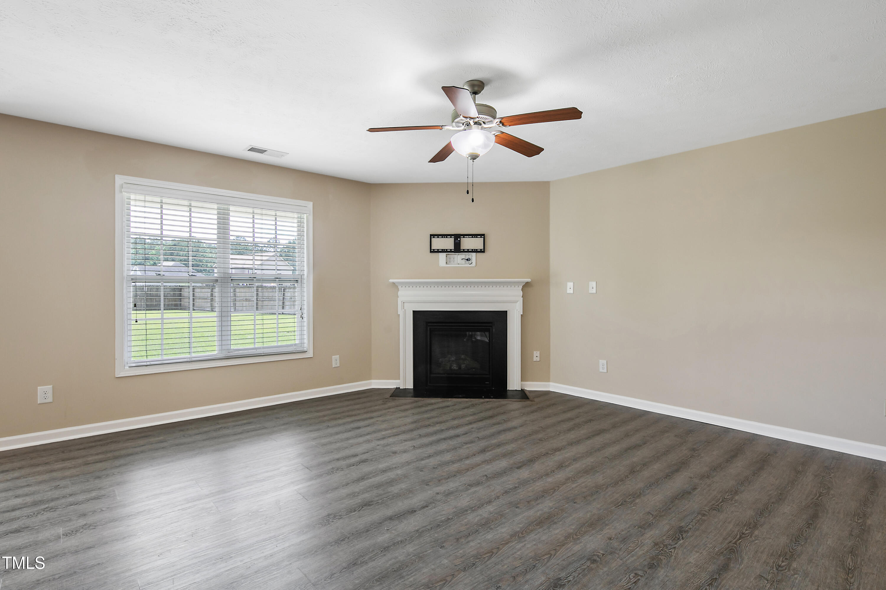 949 Raspberry Road Stedman, NC 28391 - Photo 8 of 31 a view of an empty room with wooden floor and a window