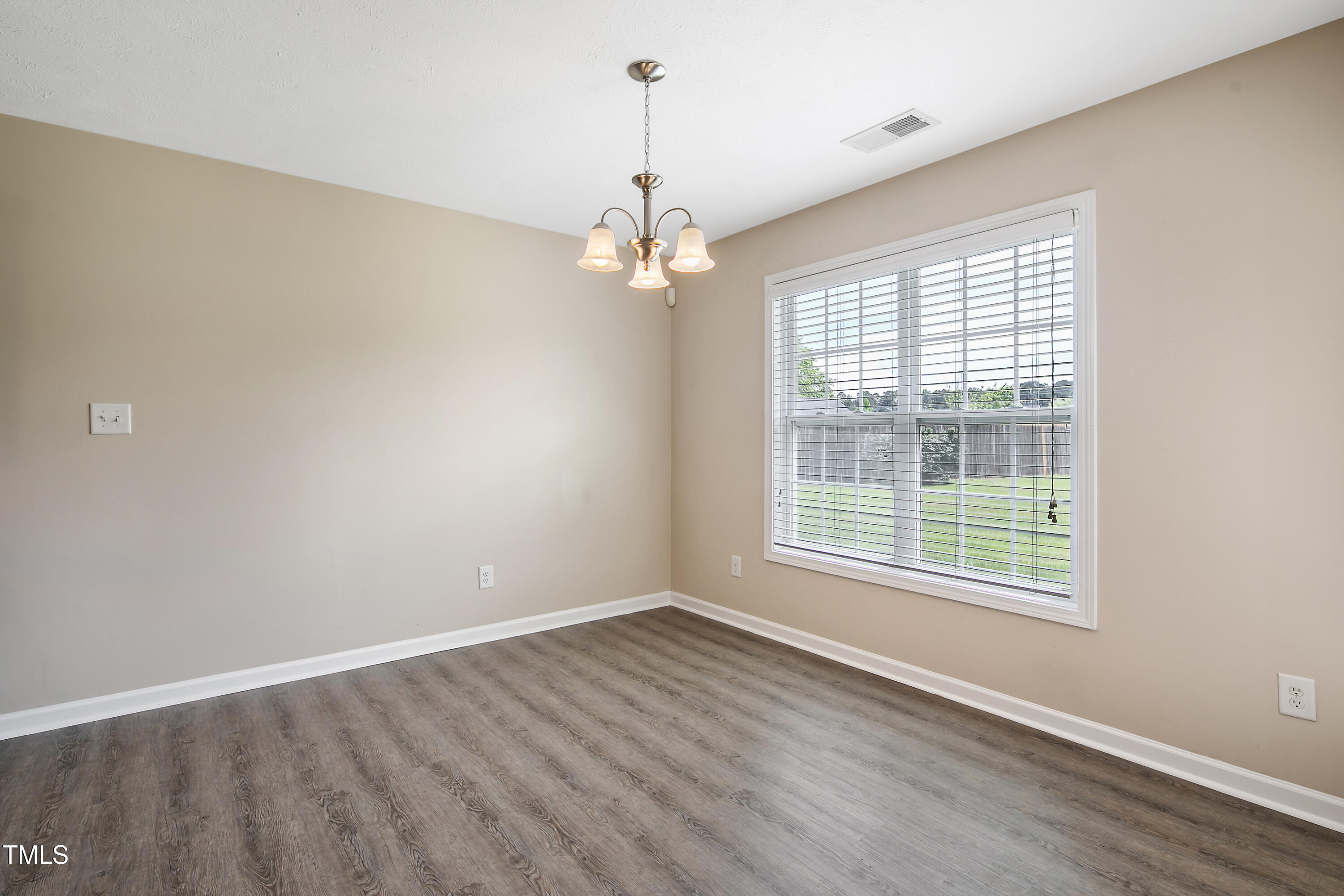 949 Raspberry Road Stedman, NC 28391 - Photo 9 of 31 wooden floor in an empty room with a window