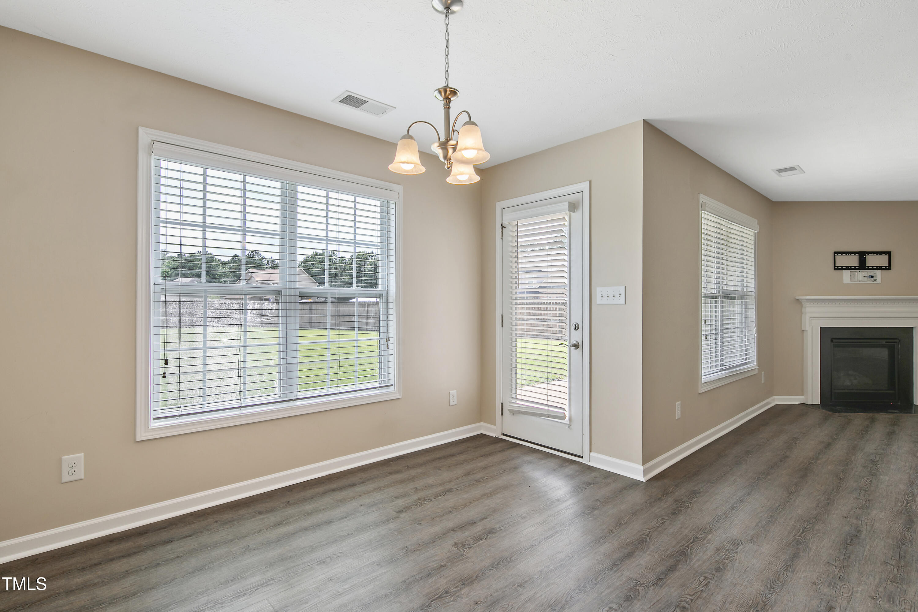 949 Raspberry Road Stedman, NC 28391 - Photo 10 of 31 a view of an empty room with window and wooden floor