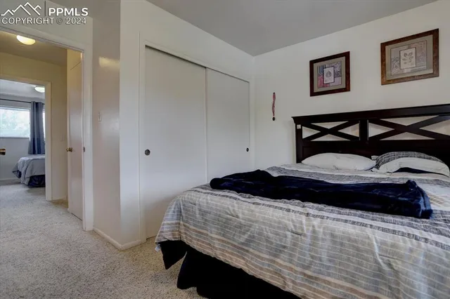 a bedroom with a bed and a view of bedroom