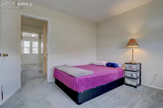 a bedroom with a bed and a lamp