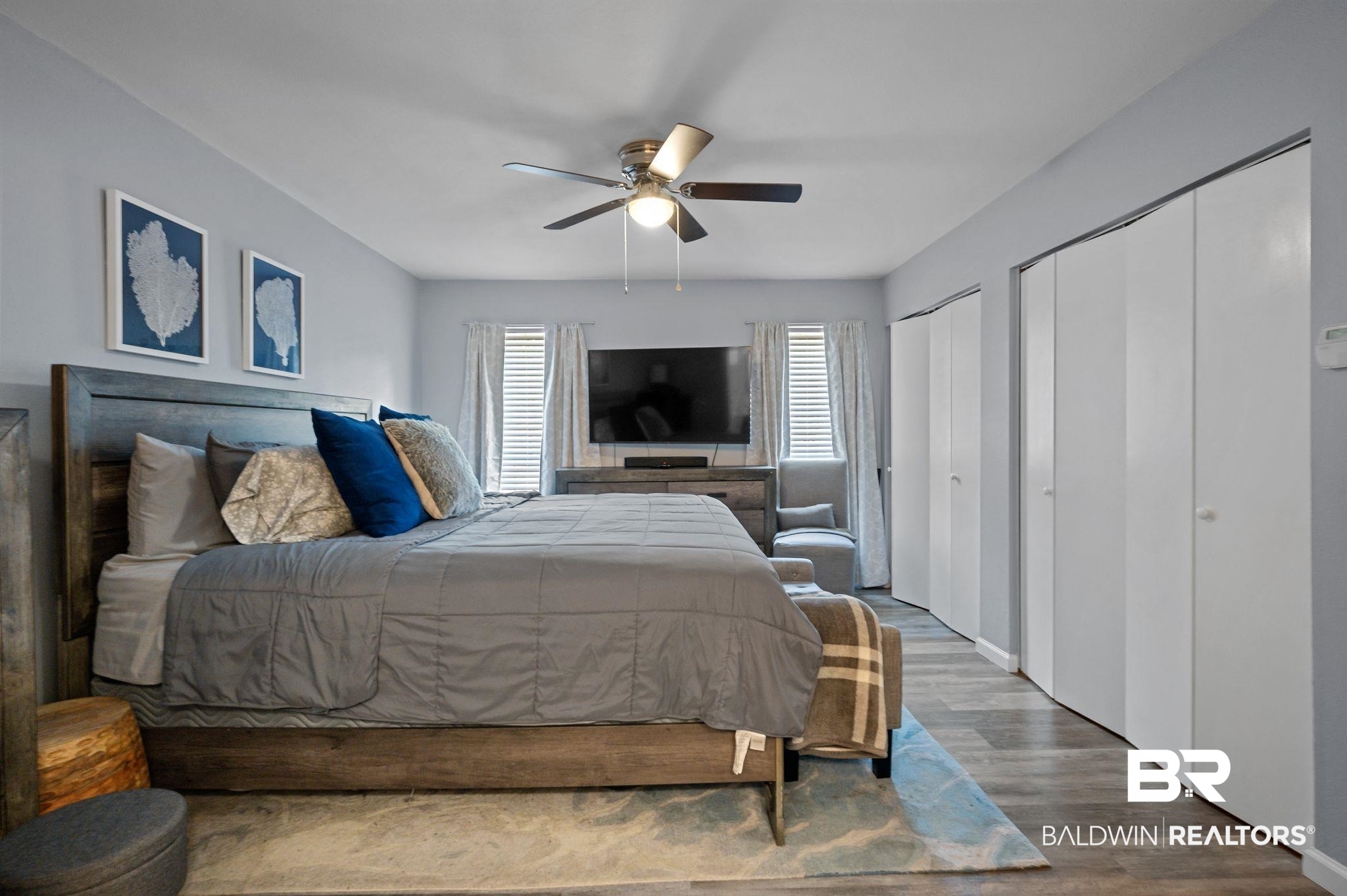 4724 Wicker Way Mobile, AL 36609 - Photo 21 of 36 Spacious room featuring wood-finish flooring, a ceiling fan, and multiple bi-fold closet doors