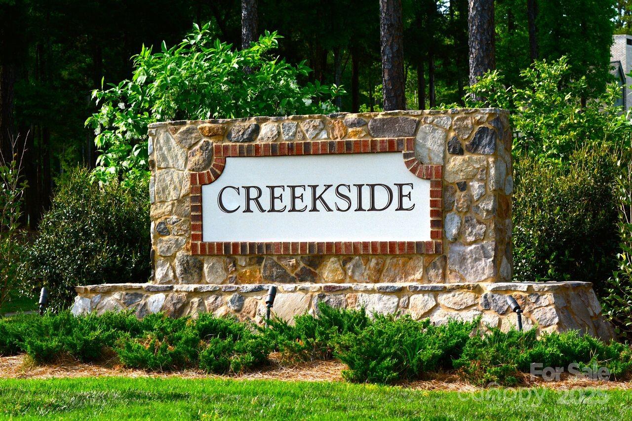 3900 Piaffe Avenue, Unit 92 Mint Hill, NC 28227 - Photo 8 of 17 a view of outdoor space with signage and flags