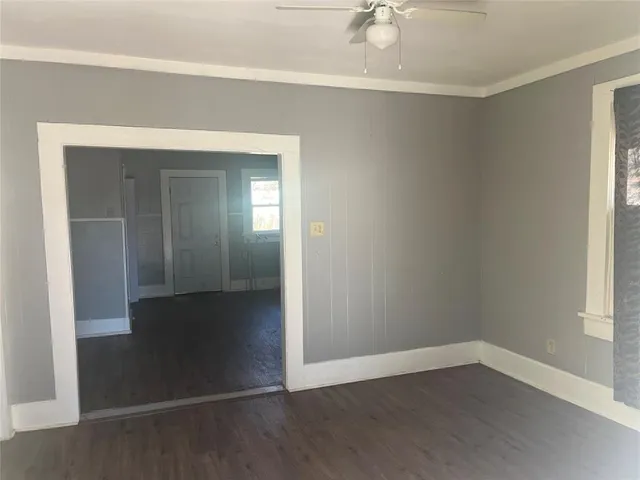 an empty room with wooden floor and closet