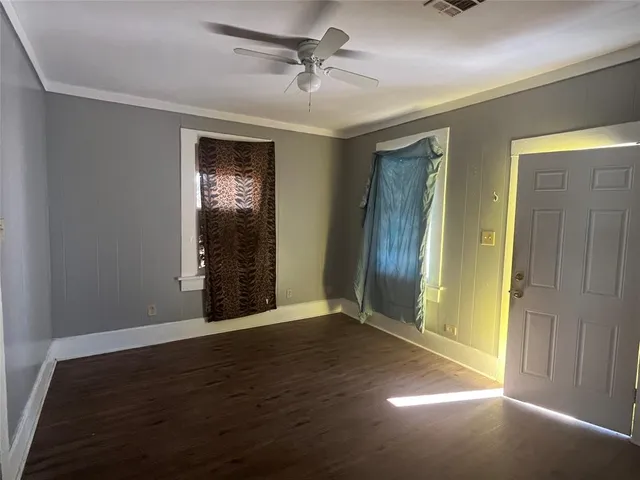 a view of an empty room with closet and a window