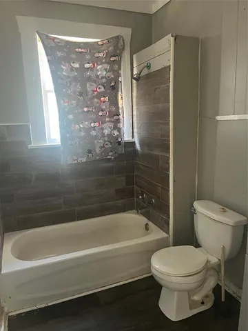 a bathroom with a toilet and a bathtub