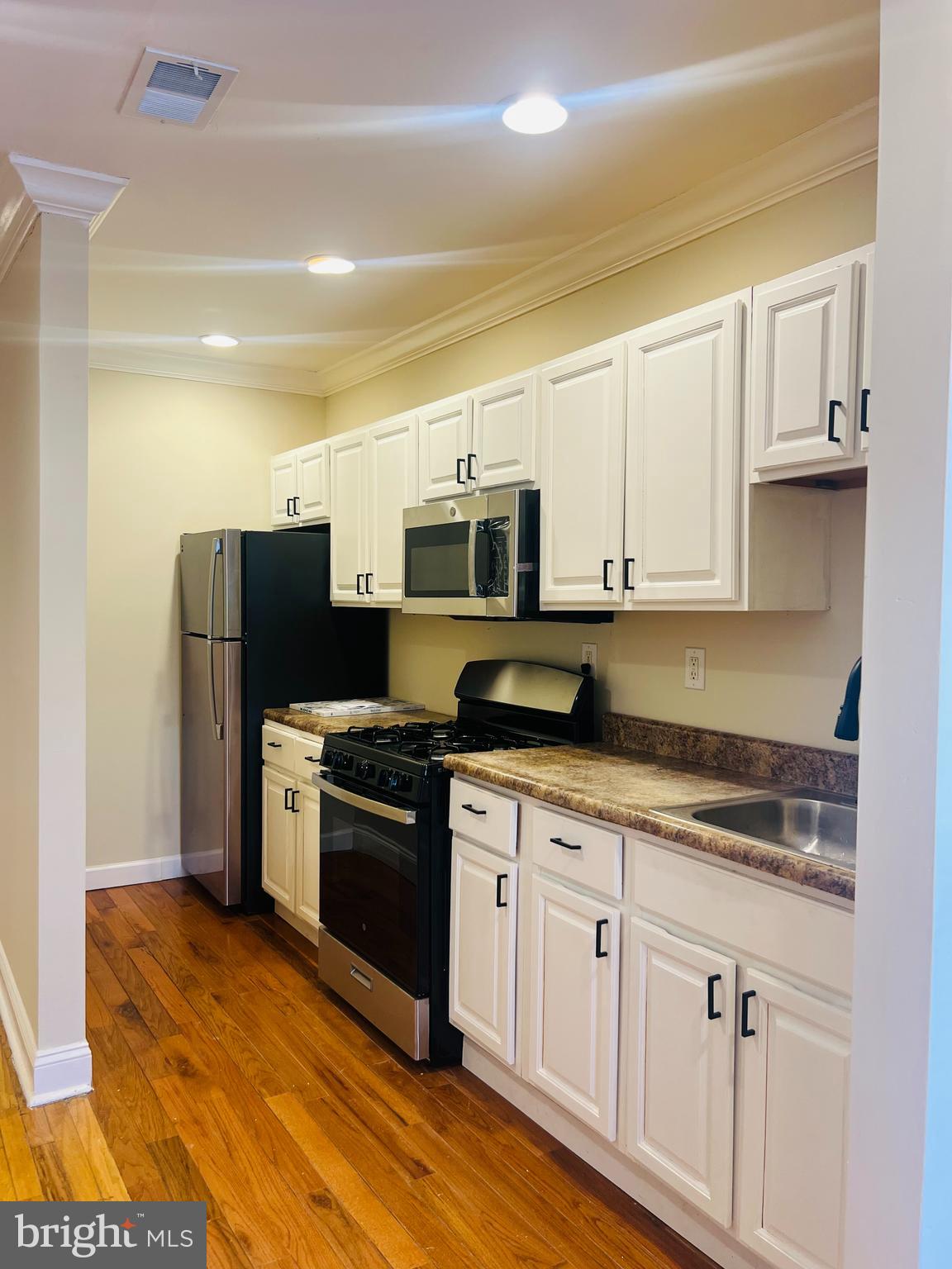 817 North 63rd Street, Unit 3 Philadelphia, PA 19151 - Photo 1 of 10 a kitchen with stainless steel appliances granite countertop a stove a sink and a refrigerator