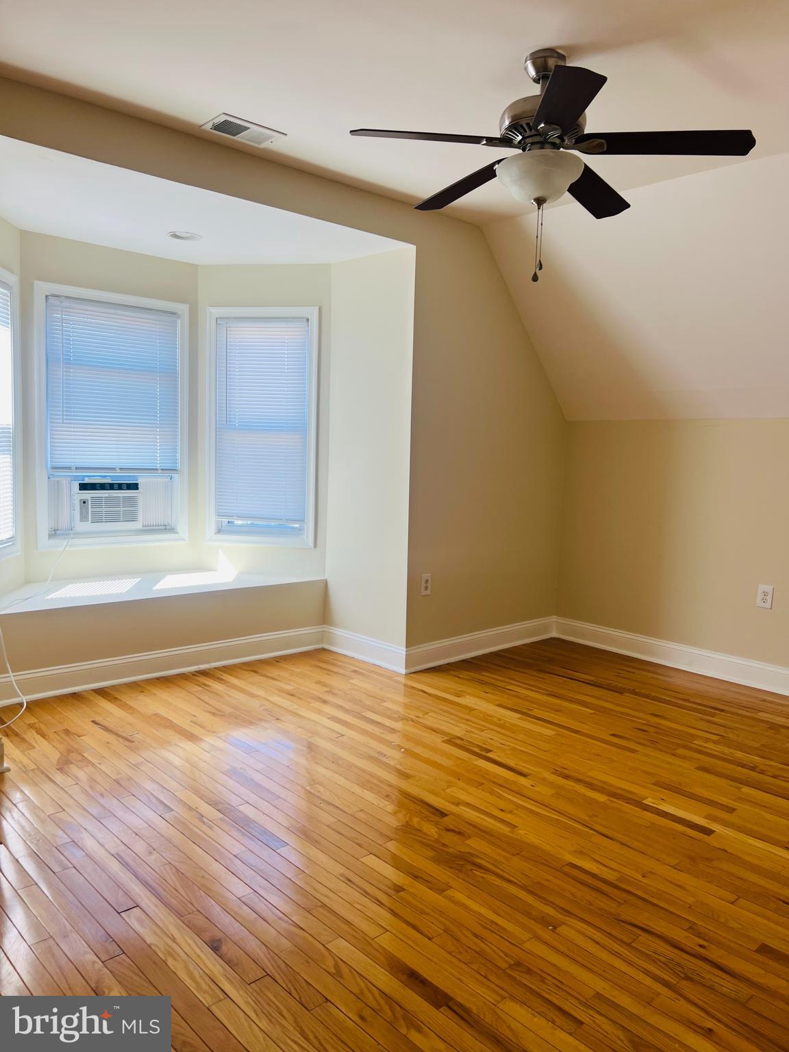 817 North 63rd Street, Unit 3 Philadelphia, PA 19151 - Photo 7 of 10 a view of an empty room with a window and wooden floor
