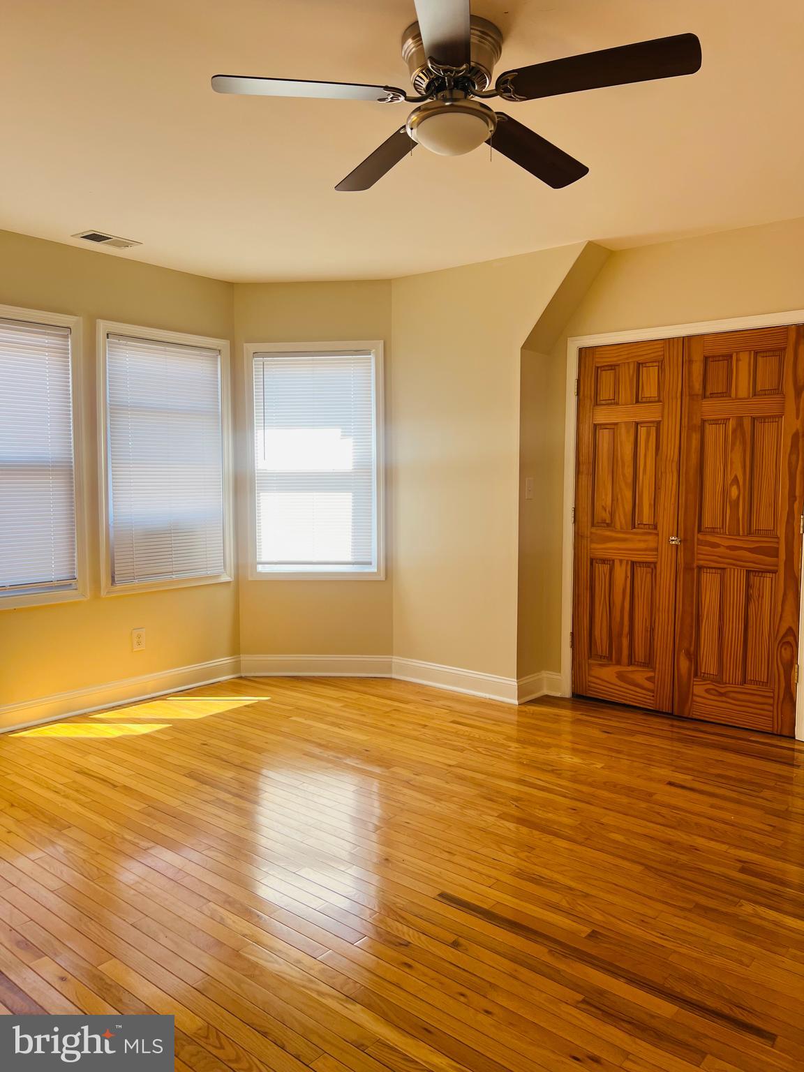 817 North 63rd Street, Unit 3 Philadelphia, PA 19151 - Photo 9 of 10 an empty room with wooden floor fan and windows
