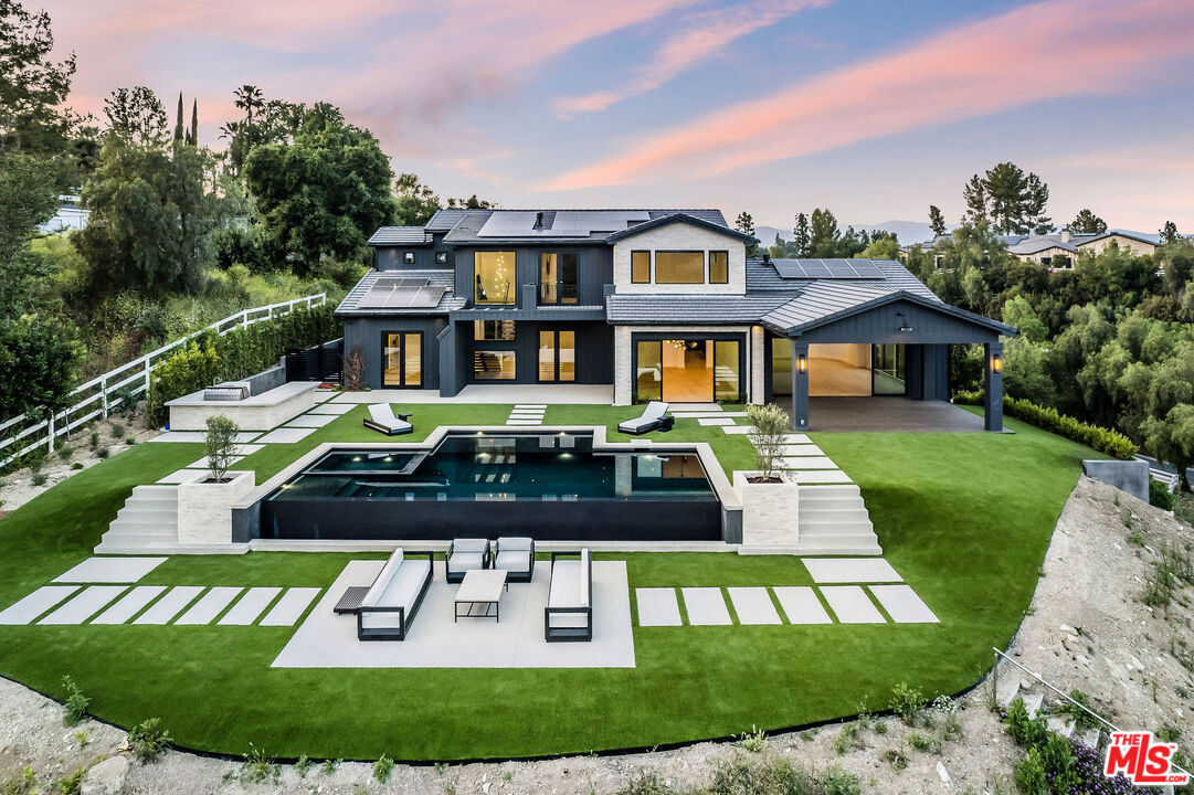 a front view of a house with a yard table and chairs