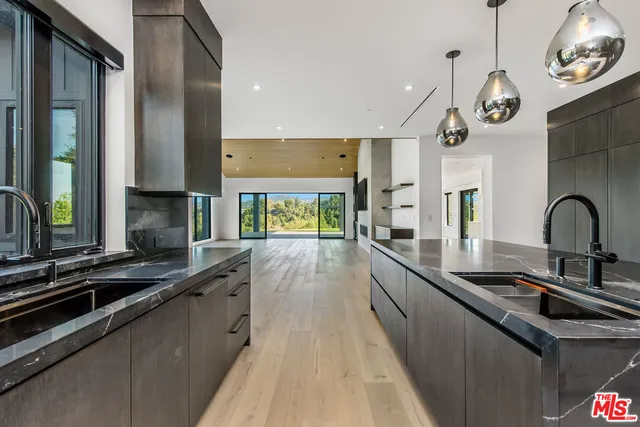 a kitchen with stainless steel appliances granite countertop a sink and a stove