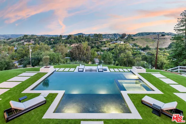 a view of yard with swimming pool and green space