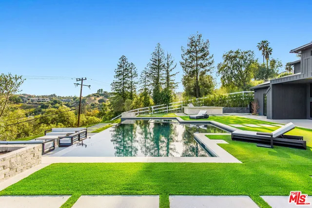 a view of a swimming pool with a lounge chairs