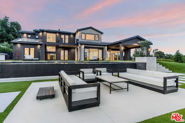 a view of an house with backyard patio and fire pit