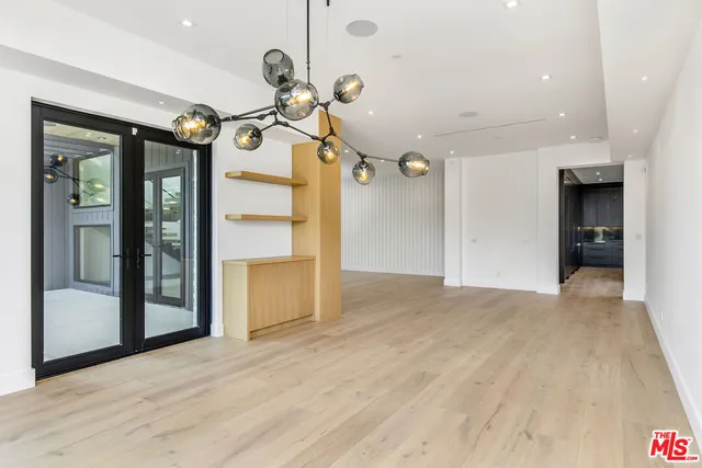 a view of a room with wooden floor and stairs