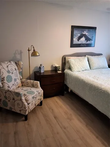 a bedroom with a bed and a painting on the wall