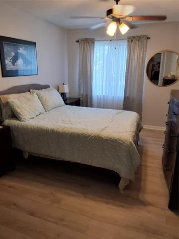 a bedroom with a bed a window and dresser