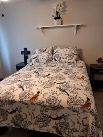 a large bed in a bedroom next to a window