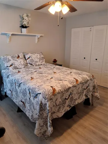 a bedroom with a bed and a chandelier
