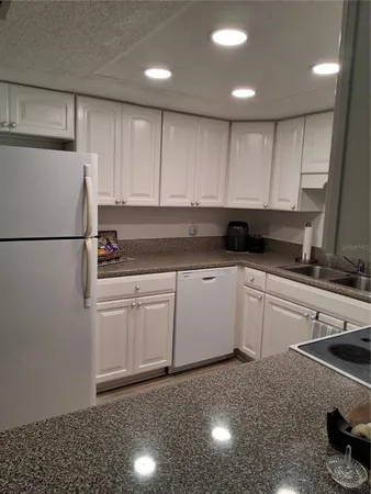 a kitchen with a sink stainless steel appliances and cabinets